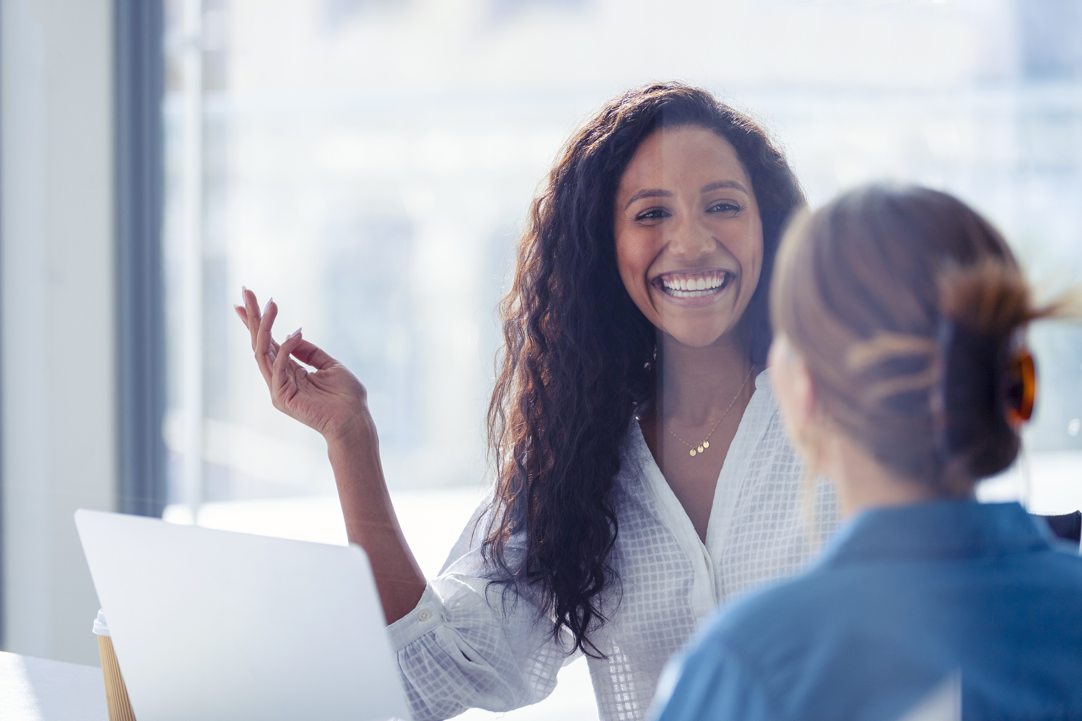 Two business women looking at computer.